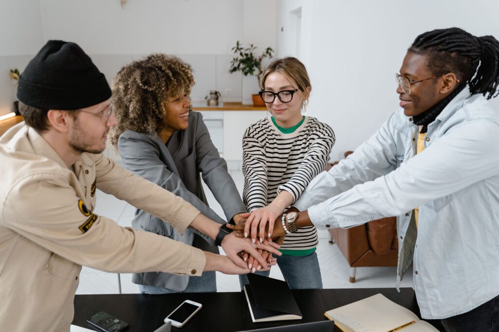 A diverse group of office co-workers sharing a team bonding moment.