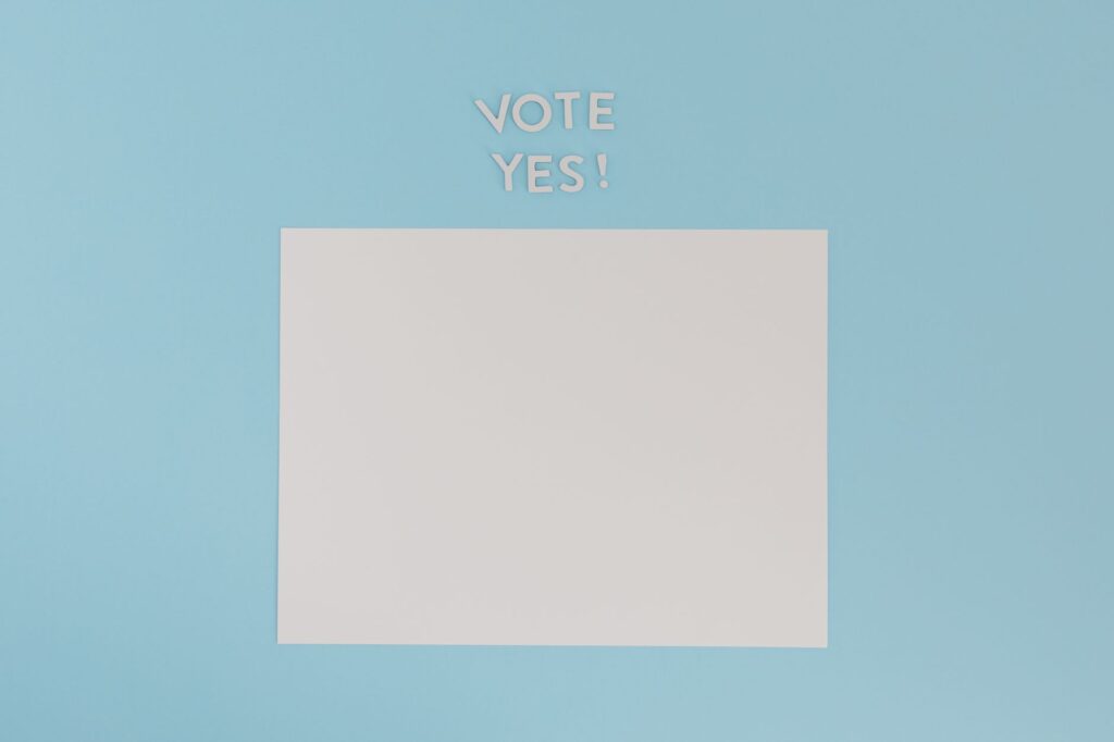 A blank sheet of paper with 'Vote Yes!' text on a blue background, ideal for conceptual designs.