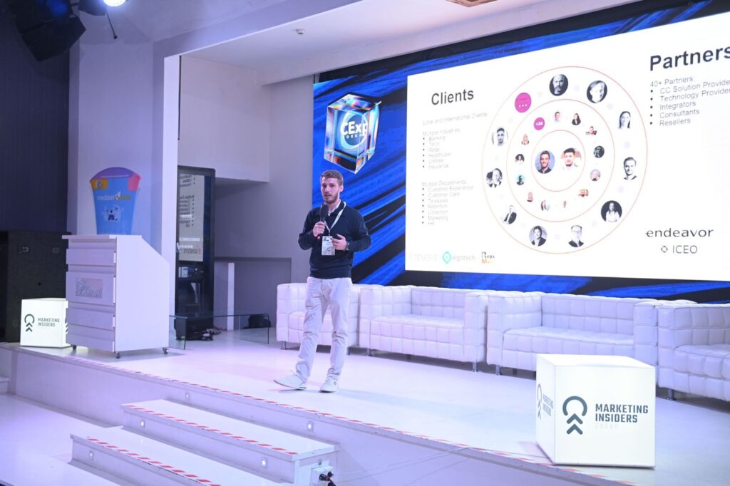 Alin Roșca on stage in front of a screen showing RepsMate